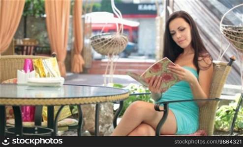Woman reading menu in a cafe