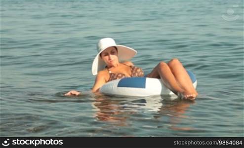 Woman resting on floating inner tube