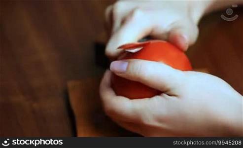 Woman's hand making red rose with tomato timelapse