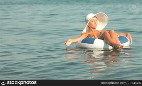 Woman spends summer vacation floating in the sea