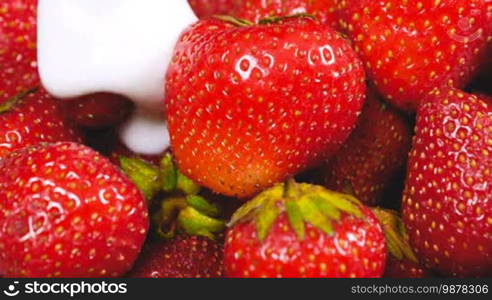 Yogurt flowing on fresh strawberries. Healthy breakfast concept.