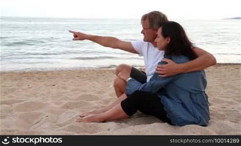Young couple on the beach in the evening