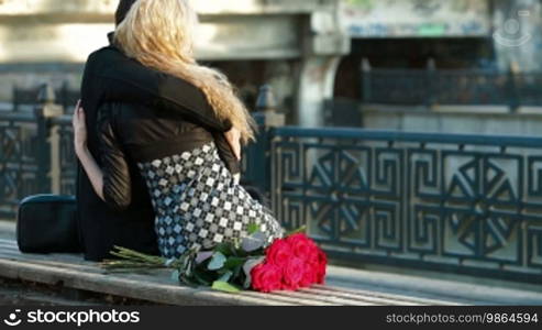 Young couple resting on the promenade in the city