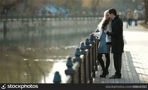Young couple walking along the promenade in the city