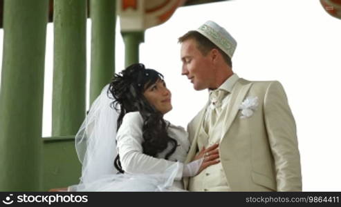 Young Crimean Tatar couple on the steps of the Big Khan Mosque in Bakhchisaray Palace. Bakhchisaray, Crimea, Ukraine