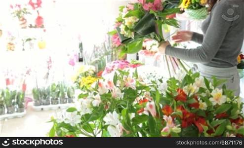 Young Female Florist Creating Bouquet Of Alstroemeria In Flower Shop