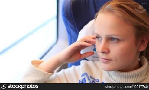 Young girl is traveling by a high-speed train.