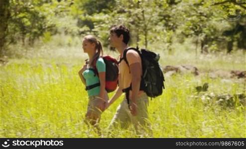 Young man and woman walking during excursion in the woods, boyfriend and girlfriend kissing, hiking and trekking on mountain. Part 6 of 12