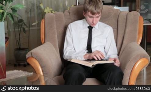 Young man prepares for studying at home.