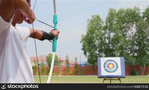 Young man training at archery with bow and arrows, people, sports, fun and leisure, recreation. 3 of 26