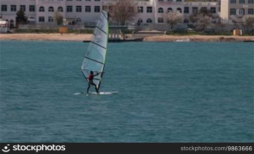 Young man windsurfing