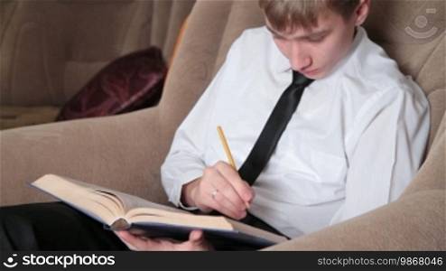 Young man with pencil in hand prepares for study.