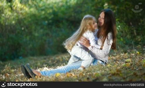 Young mother and daughter having a great day in the park