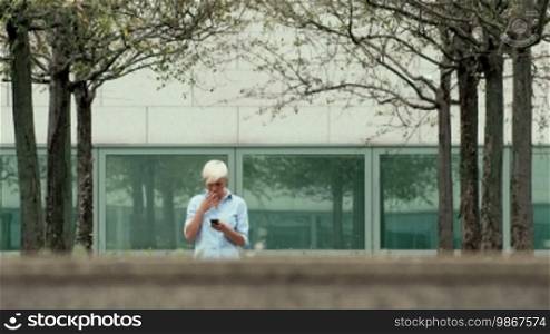 Young people and smokers, businesswoman smoking a cigarette near an office building. Part 1 of 6