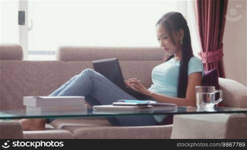 Young people at home, lifestyle, education and technology, portrait of happy beautiful Asian girl studying for school homework on laptop computer. 1 of 22