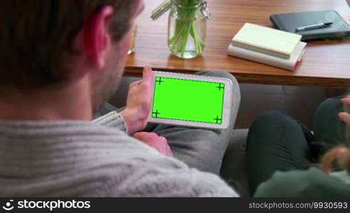 Young people at home, man and woman lifestyle, boyfriend and girlfriend relax, college students studying with iPad tablet, computer green screen, monitor. Education, friends, internet, email, website