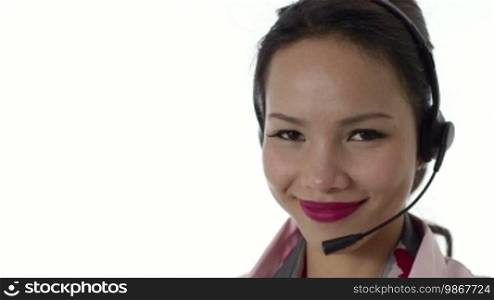 Young people, work and technology, portrait of a happy Asian girl working as a call center operator with a headset, customer care representative, smiling at the camera. 12 of 16