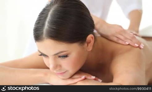 Young woman being massaged in spa salon