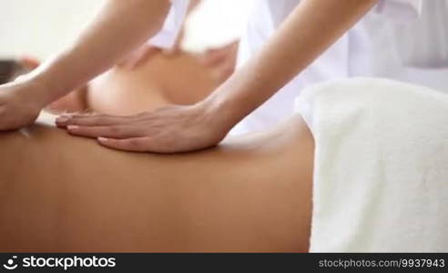 Young woman being massaged in spa salon
