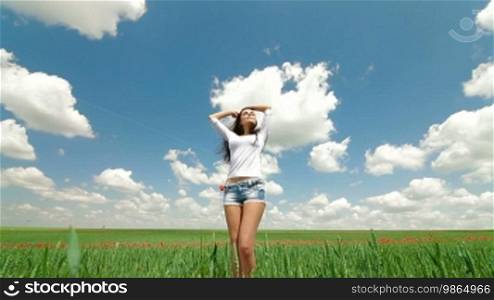 Young Woman Enjoying Summer Day In The Field