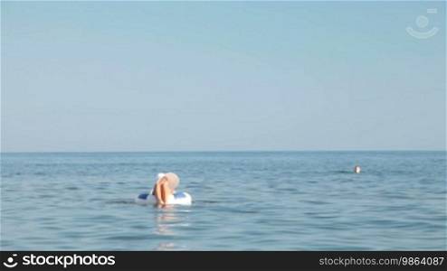 Young woman floating on inner tube