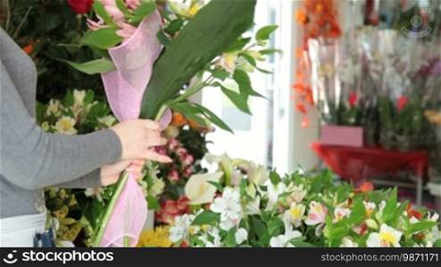 Young Woman Florist Making Alstroemeria Bouquet In Flower Shop