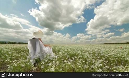 Young Woman On White Field In Summer - Tracking shot