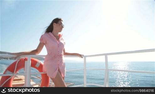 Young woman relaxing on the deck of the sailing ship