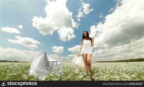 Young Woman Walking Through Summer Field, Front View