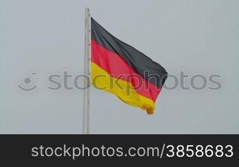 Video shot of German flag flapping with sky background