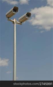 video surveillance cameras against blue sky background