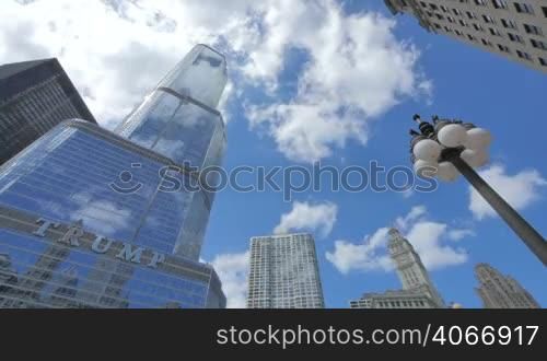 Video timelapse of Chicago downtown skyscraper at the city center financial district in the United States of America. Trump Tower in Chicago is one of the highest buildings in the city center. Clouds reflected on the facade glasses.