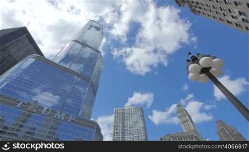 Video timelapse of Chicago downtown skyscraper at the city center financial district in the United States of America. Trump Tower in Chicago is one of the highest buildings in the city center. Clouds reflected on the facade glasses.