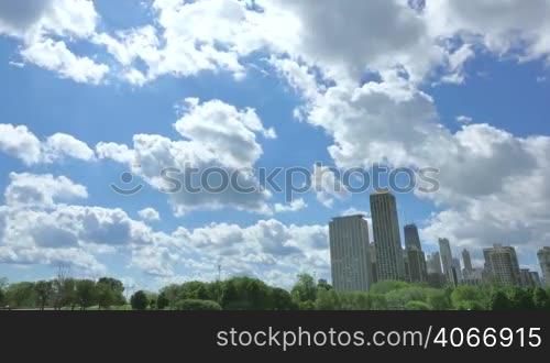 Video timelapse of Chicago downtown skyscrapers at the city center financial district. Hancock Tower in Chicago city center in the United States of America. Cloudscape with white clouds crossing fast over the city skies.