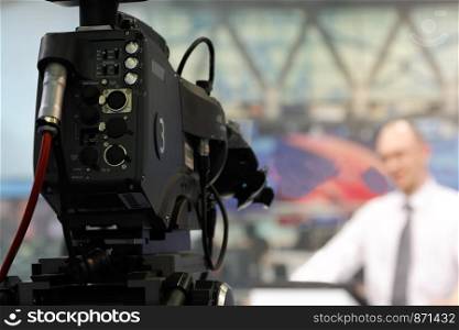 Videocamera in a TV news studio with blurred background