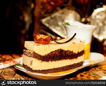 Vienna cake with almond and caramel at dark background