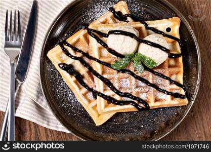 viennese waffles with chocolate syrup on a wooden. viennese waffles with chocolate syrup