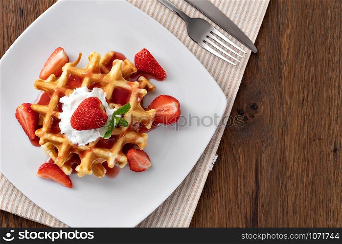 viennese waffles with strawberry and sweet syrup. viennese waffles with strawberry