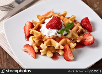 viennese waffles with strawberry and sweet syrup. viennese waffles with strawberry