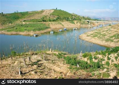 Vietnam countryside landscape, impression chain of mountain cover Nam Ka lake, bare hill from deforestation, amazing scene with floating house on river, residential on water