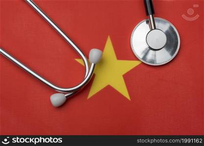 Vietnam flag and stethoscope. The concept of medicine. Stethoscope on the flag in the background.. Vietnam flag and stethoscope. The concept of medicine.