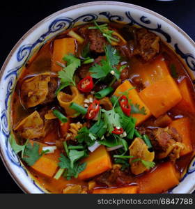 Vietnam food, bread with stewed beef, a popular meal at morning, eat attach parsley, basil, lemon pepper and salt make so delicious taste