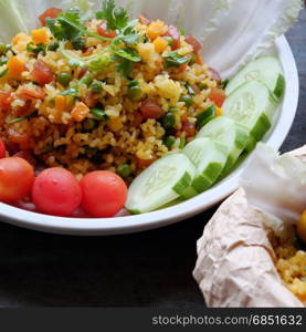 Vietnam food, fried rice, make from rice, egg, sausage, dried shrimp, bean, cucumber, tomato, carrot and scallion, close up of dish on wooden background