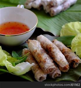 Vietnamese egg roll or spring roll or cha gio is popular food at Vietnam cuisine, stuffing from meat and wrapper by rice paper, then deep fried, eat with salad and fish sauce