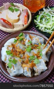 Vietnamese food, Banh Cuon name Rice noodle roll or rolled cake, is made from rice batter filled with mushroom, pork, served with Vietnam pork sausage, sliced cucumber, bean sprouts and sauce
