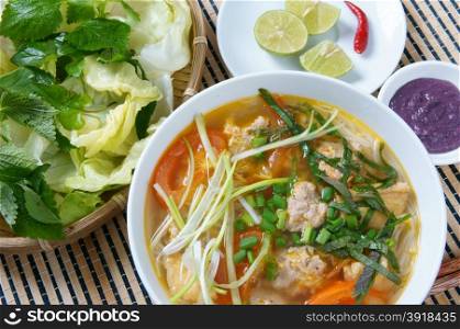 Vietnamese food, bun rieu, a famous dish of Vietnam, raw material as tomato, crab, pork meat, shrimp, salad, scallion, egg, vegetable, shrimp paste, bunrieu is Viet Nam special eating