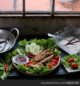 Vietnamese food for family meal at lunch or dinner, fried fish with tamarind sauce and green vegetable, delicious food homemade on wooden background