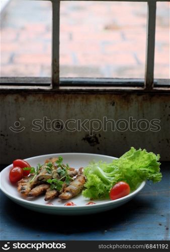 Vietnamese food for family meal at lunch or dinner, fried fish with tamarind sauce and green vegetable, delicious food homemade on wooden background