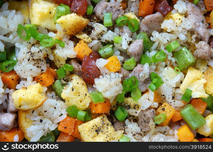 Vietnamese food, fried rice, a delicious Asian eating, raw material as carrot, cooked rice, meat, egg, sausage, onion, garlic, this meal rich cholesterol, calories