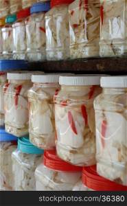 Vietnamese food in rainy season, bamboo shoot show on food store at marketplace, agriculture product process and keep in plastic jar